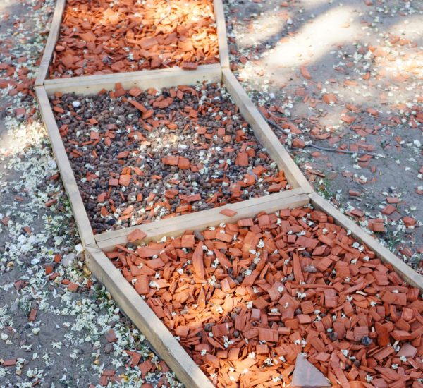 A vertical shot of material pieces in wooden boxes
